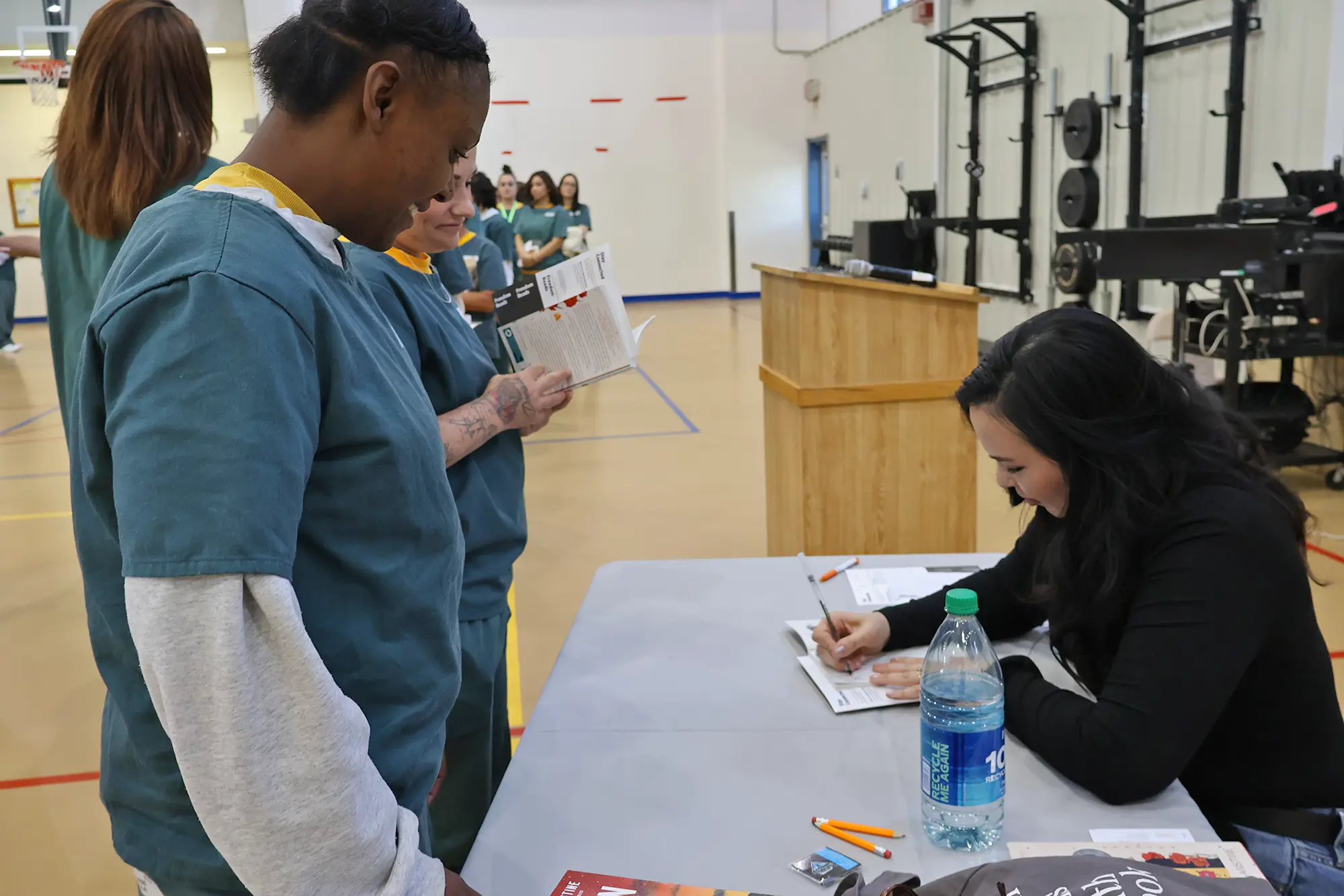 Women at La Vista Correctional Facility in Colorado wait in line eagerly for writer Kali Fajardo-Anstine to sign their copies of Woman of Light after a reading.